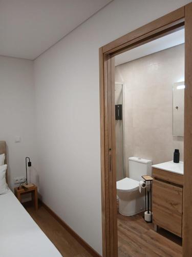 a bathroom with a toilet and a sink at Casinhas do Campo by Gerês Valley in Campo do Gerês