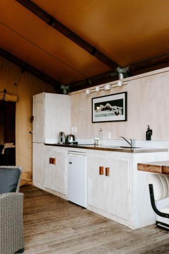 a kitchen with white cabinets and a counter top at Te Mata Views Resort in Havelock North