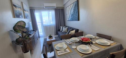 a dining room with a table and chairs and a room with at Spacious Condo with free parking in Lapu-lapu City in Mactan Island
