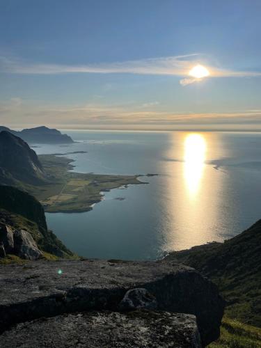 a view of the sun setting over the ocean at House on Leknes, in the middle of Lofoten in Vestvågøya