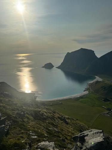 a view of a body of water with the sun in the sky at House on Leknes, in the middle of Lofoten in Vestvågøya