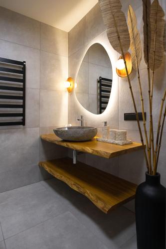 a bathroom with a sink and a mirror at Balimood Stay in Palanga