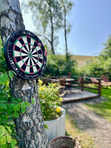 a dart board on the side of a tree at Ales BnB Lägenheten in Löderup