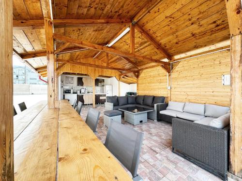 a large living room with a wooden ceiling at Relax by the Sea Rooms next to Nibiru in Costinesti