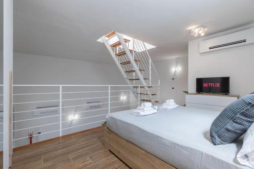 a bedroom with a bed with a ladder on the wall at Valentini Luxury Loft-18 by train to Florence-PARKING FREE in Prato