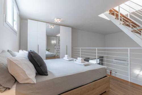 a bedroom with a large bed and a staircase at Valentini Luxury Loft-18 by train to Florence-PARKING FREE in Prato
