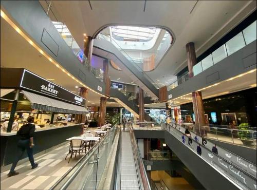 a shopping mall with a person walking through it at Happy Place Apartment in Gatunga