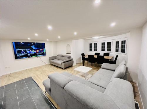a living room with a couch and a dining room at Gemütliches Wohnung für Familien und Gruppen in Küblis