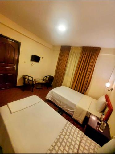 a hotel room with a bed and a window at Keba Guest INN in Addis Ababa