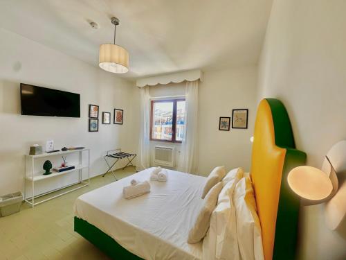 a bedroom with a bed and a television in it at suite sorrento center in Sorrento