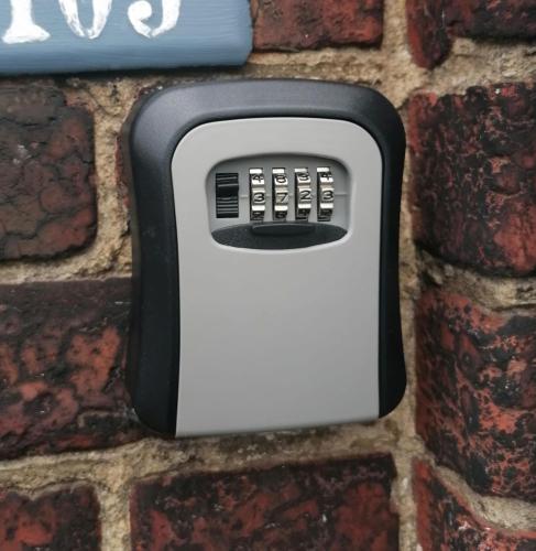 a soap dispenser attached to a brick wall at Une chambre chez l'habitant près de l'aéroport de Charleroi in Charleroi