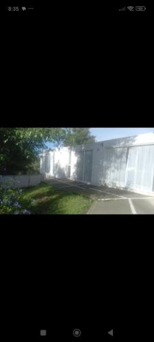 a view of a building with a yard and a street at Casa blanca in Santa María Atlihuetzián