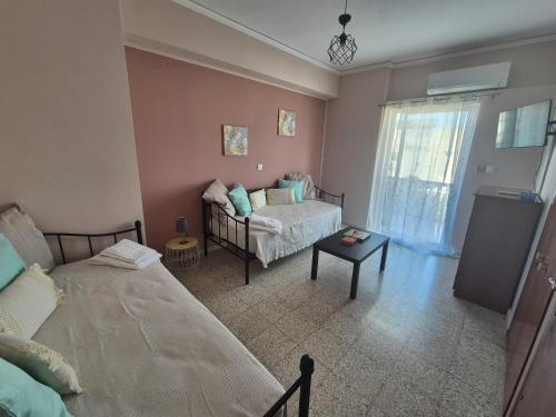 a living room with two beds and a couch at Lilia Apartments A1 in Vrahati