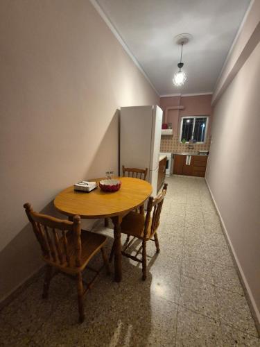 a kitchen with a table and chairs and a refrigerator at Lilia Apartments A1 in Vrahati