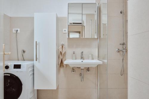 a bathroom with a sink and a washing machine at Villa Dora in Omiš centar now with Jacuzzi in Omiš
