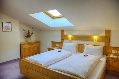 a bedroom with a large bed with a skylight at Haus Silvia in Werfenweng