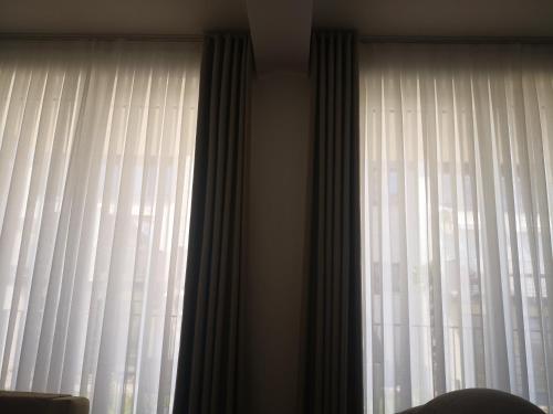 a window with white curtains in a room at Free Comfort Apartments Star Dojran in Star Dojran