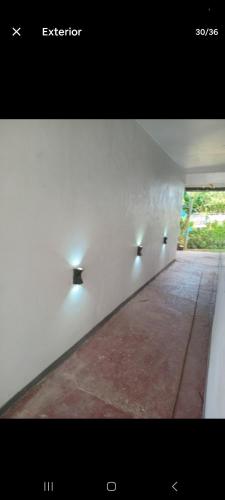 a hallway with three lights on a white wall at Aggies homestay in Nadi in Nadi International Airport