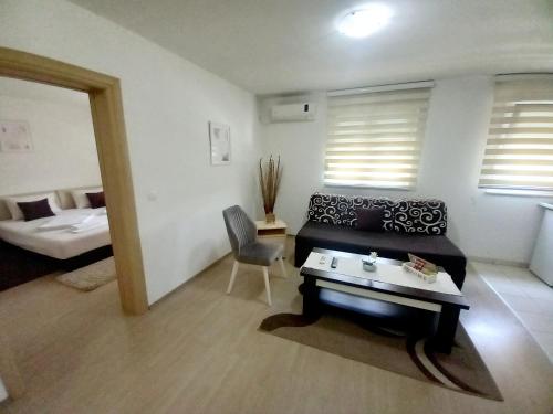 a living room with a couch and a bed at Apartments Platz in Mostar