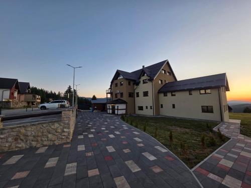 a rendering of a house with a driveway at Crown Apartmani Vlašić in Vlasic