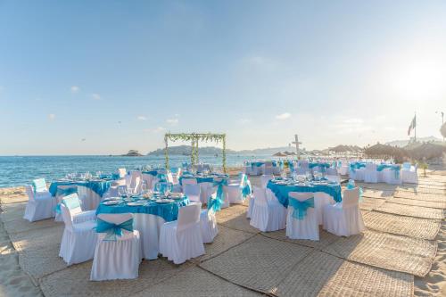 a group of tables and chairs on the beach at Krystal Beach Acapulco in Acapulco