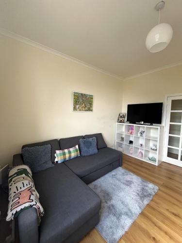 a living room with a couch and a flat screen tv at Edinburgh Centre - George Square Residence in Edinburgh