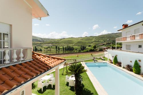 a view of the pool from the balcony of a house at Casa do Carril - Private Pool - Douro Valley in Peso da Régua