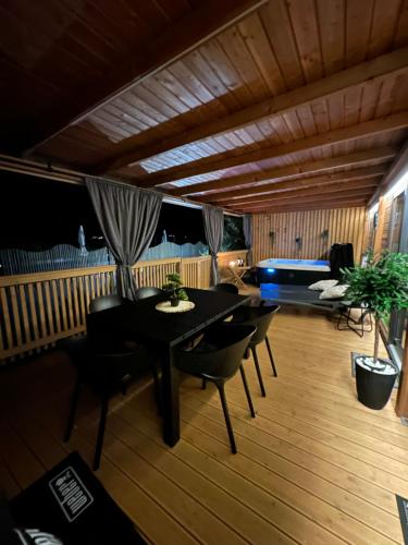 a dining room with a table and chairs and a pool at Mobile home LUNA Selce in Selce
