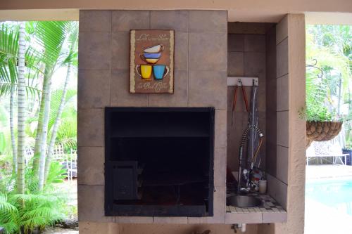 a fireplace in a living room with a fire place at Tengo guest house in Phalaborwa