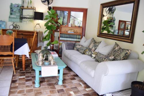 a living room with a couch and a table at Tengo guest house in Phalaborwa