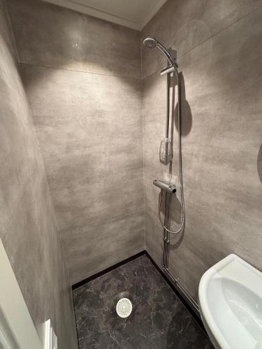 a bathroom with a shower and a sink at CityBed Bed & Breakfast in Pajala