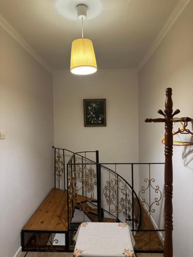 a room with a spiral staircase with a light and a ceiling at Keros House in Kalliópi