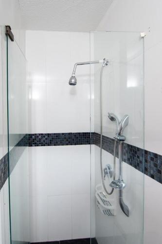 a shower in a bathroom with a glass door at El paraiso en Melgar in Melgar