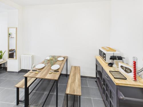 a kitchen with two tables and a microwave at Sweet stay T2 in Dreux
