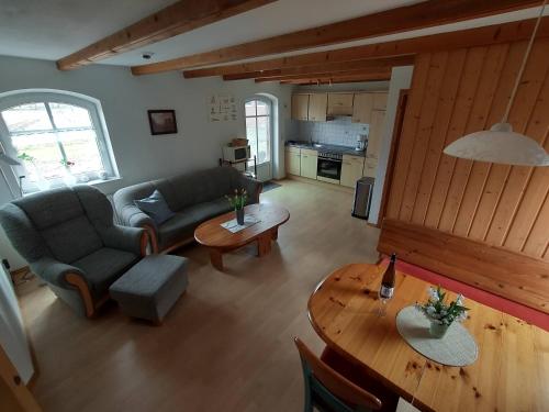 a living room with a couch and a table at Ferienhaus Gulfhof Tjaden in Großefehn 