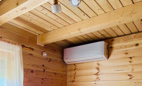 a room with a wooden ceiling with a heater at Alfa Omega Žabljak in Žabljak