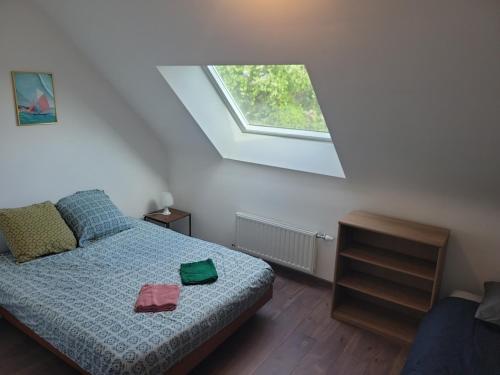 a small bedroom with a bed with a window at Maison Saint Philibert 3 chambres in Saint-Philibert
