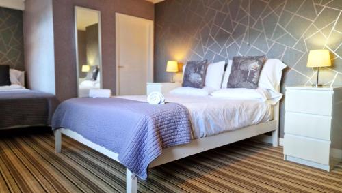 a hotel room with a bed and a mirror at The Ransdale in Bridlington