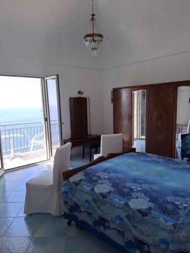a bedroom with a bed and a view of the ocean at Casa Belle Vue in Furore