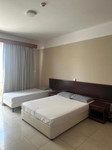 Postel nebo postele na pokoji v ubytování Ellis Hotel Apartments