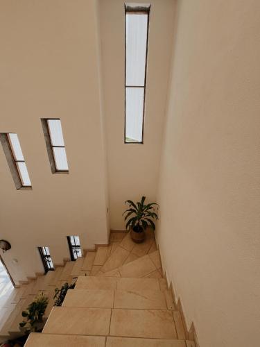 a room with a staircase with skylights at Casa Margil in Puerto Escondido