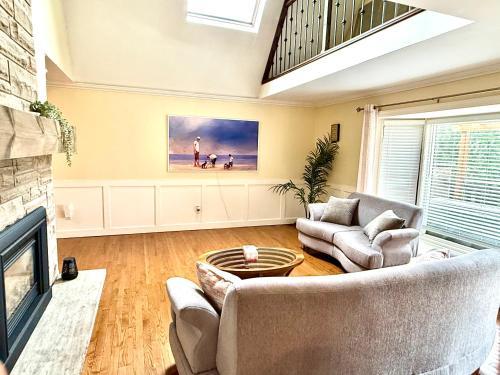 a living room with a couch and a fireplace at Mono Farmhouse in Caledon