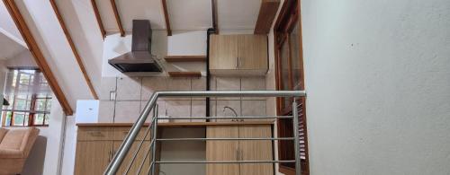 a spiral staircase in a house with a stair case at Brookyard Guest House in Pretoria
