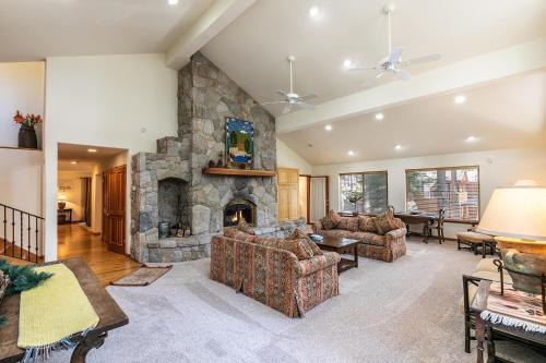 a large living room with a stone fireplace at Silver Rock Lodge home in Zephyr Cove