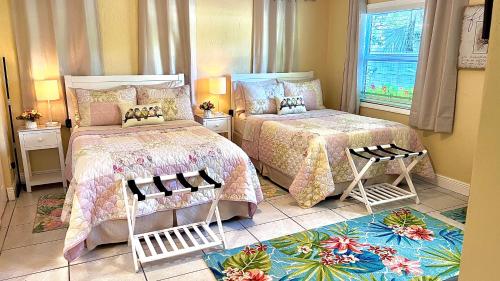 a bedroom with two beds and a window at The Boutique Guest House in Miami