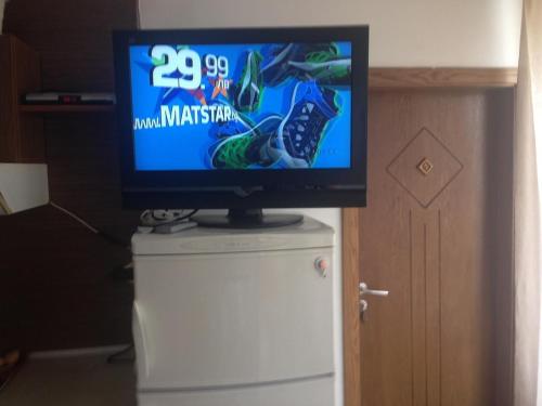 a flat screen tv sitting on top of a refrigerator at Apartment Planinski Rai in Tryavna