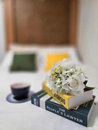 a bouquet of flowers sitting on top of books at Daon Stay in Seoul