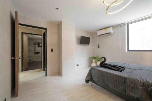 a bedroom with a bed with a black swan on it at 3 bedroom apartment, one block from lleras park p12 in medellin in El Poblado