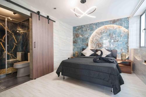 a bedroom with a bed and a bathroom at 3 bedroom apartment, one block from lleras park p12 in medellin in El Poblado