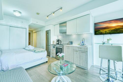 a kitchen with a bed and a table in a room at RivetStays - The Jarvis in Toronto